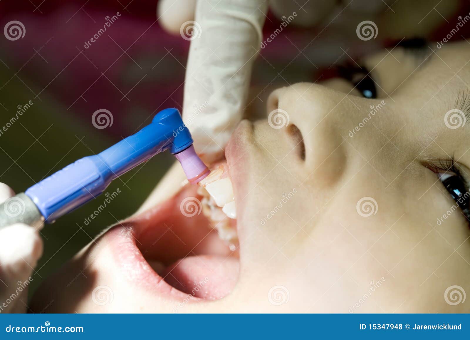 little girl having teeth cleaned at dental office