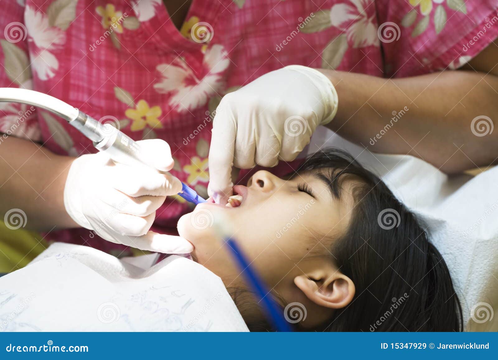 little girl having teeth cleaned at dentist