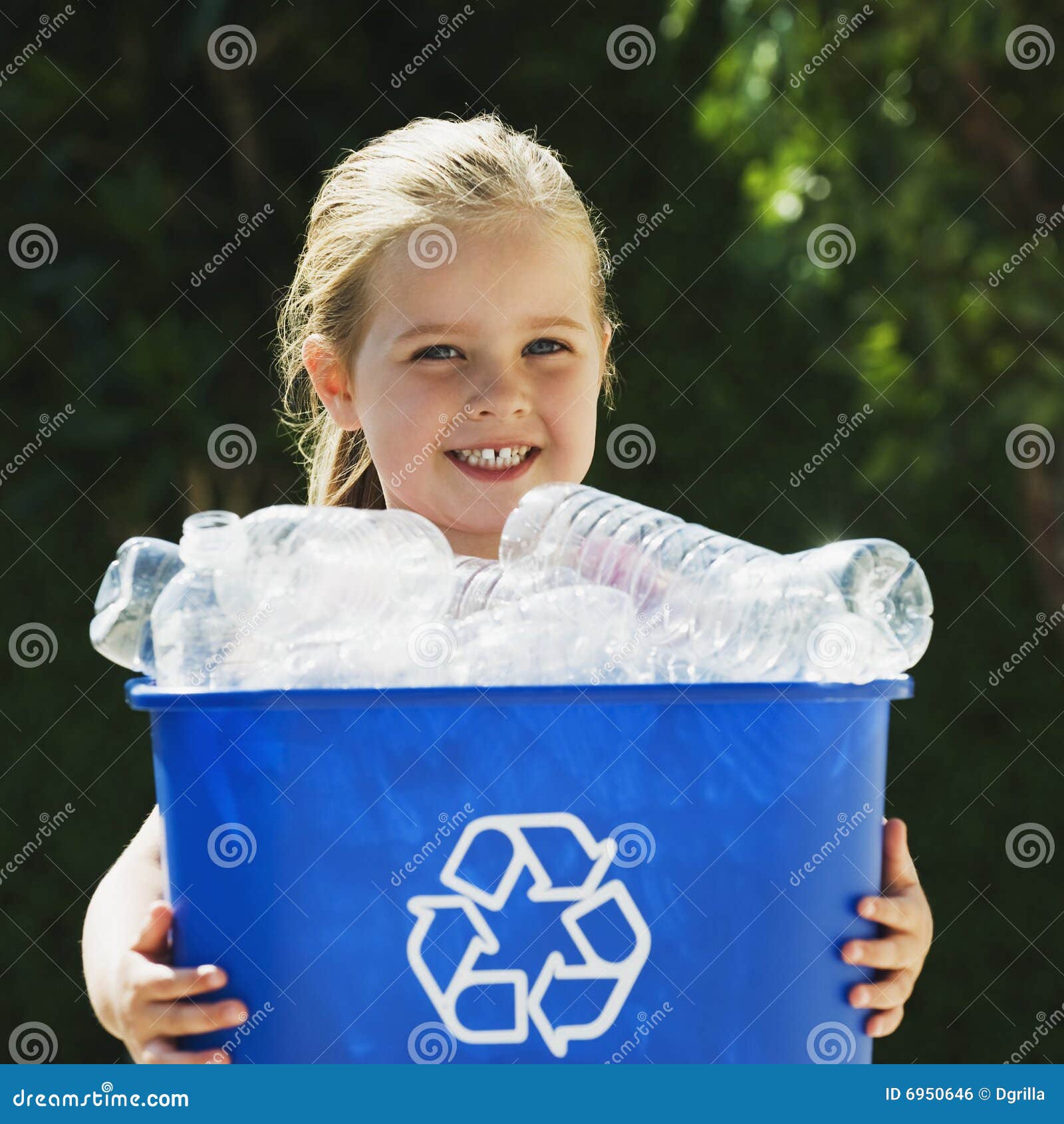 little girl holding recycling bin