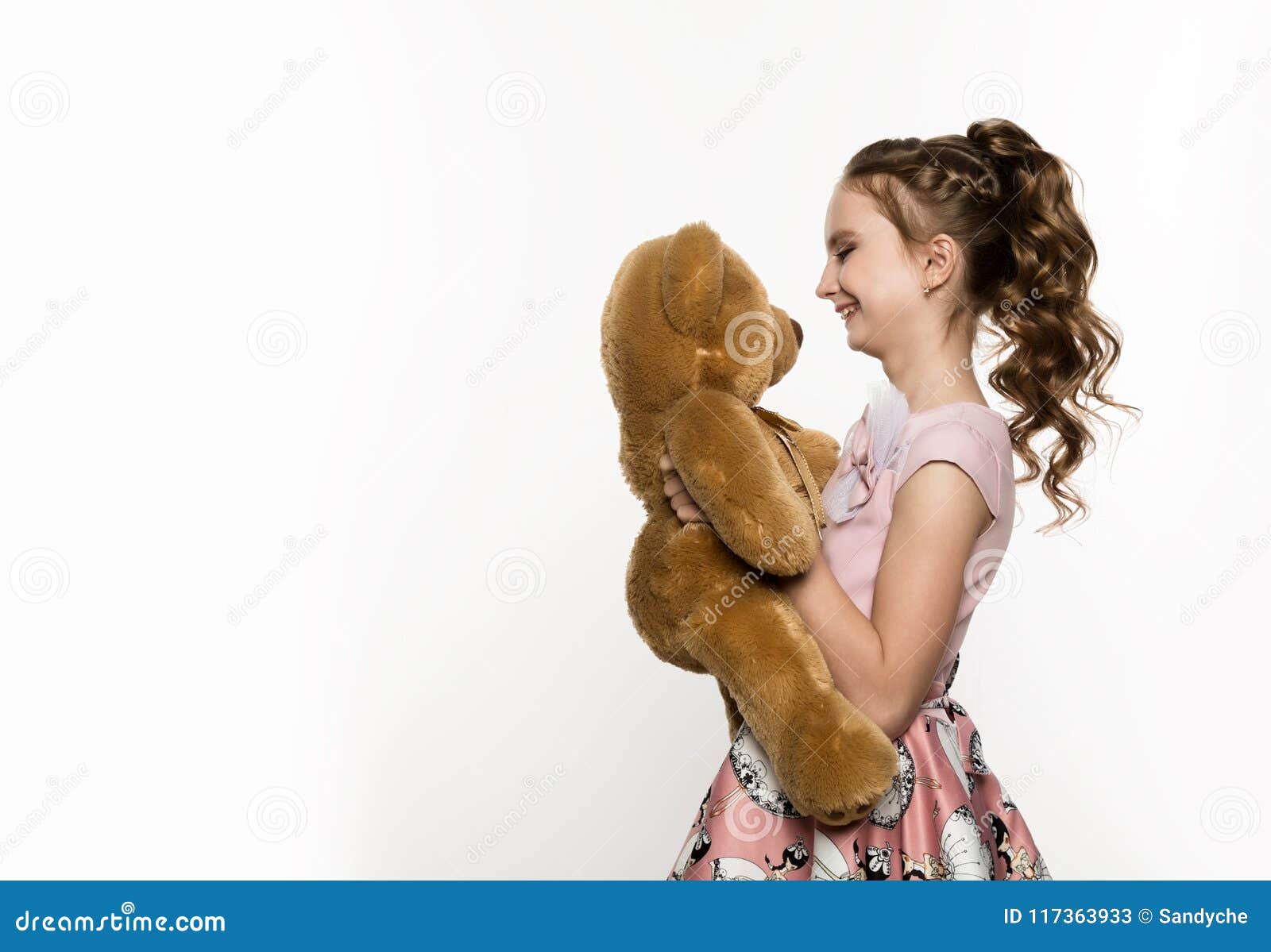 Little Girl Holding a Teddy Bear on a White Background. Free Space for ...