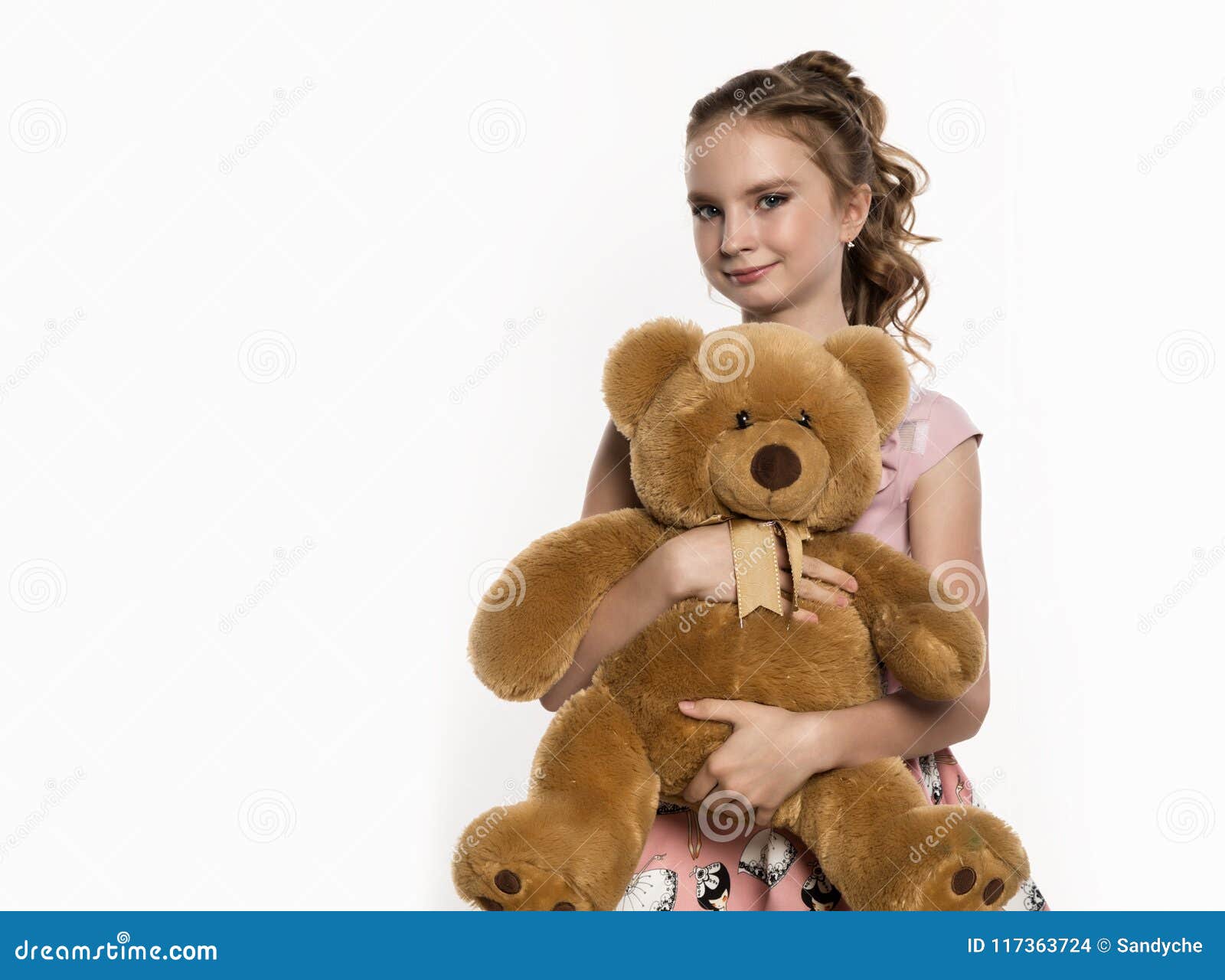 Little Girl Holding a Teddy Bear on a White Background. Free Space for ...