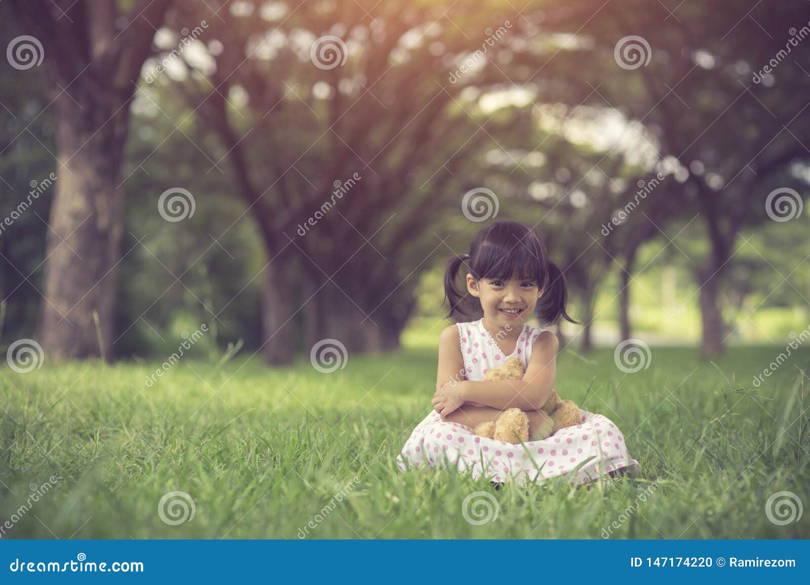 Little Girl Hugging Her Teddy Bear in Park. Stock Photo - Image of ...