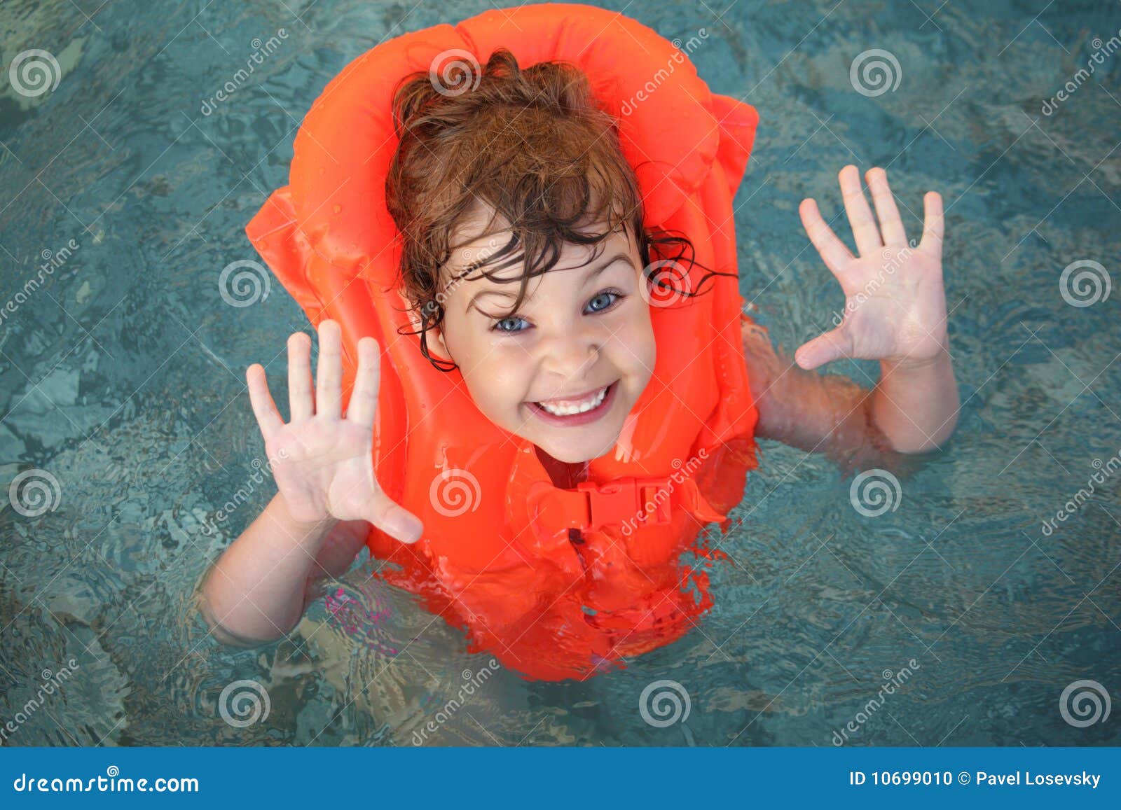 little girl in inflatable waistcoat in pool