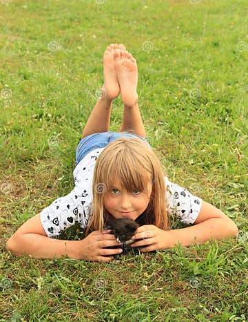 Little girl with a kitty stock photo. Image of meadow - 57351920