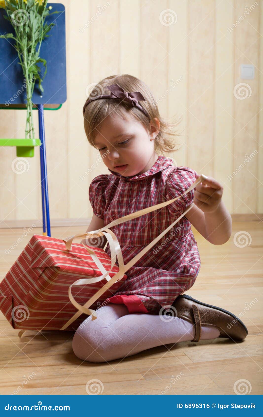 Little Girl Opening A Box With Gift Royalty Free Stock 