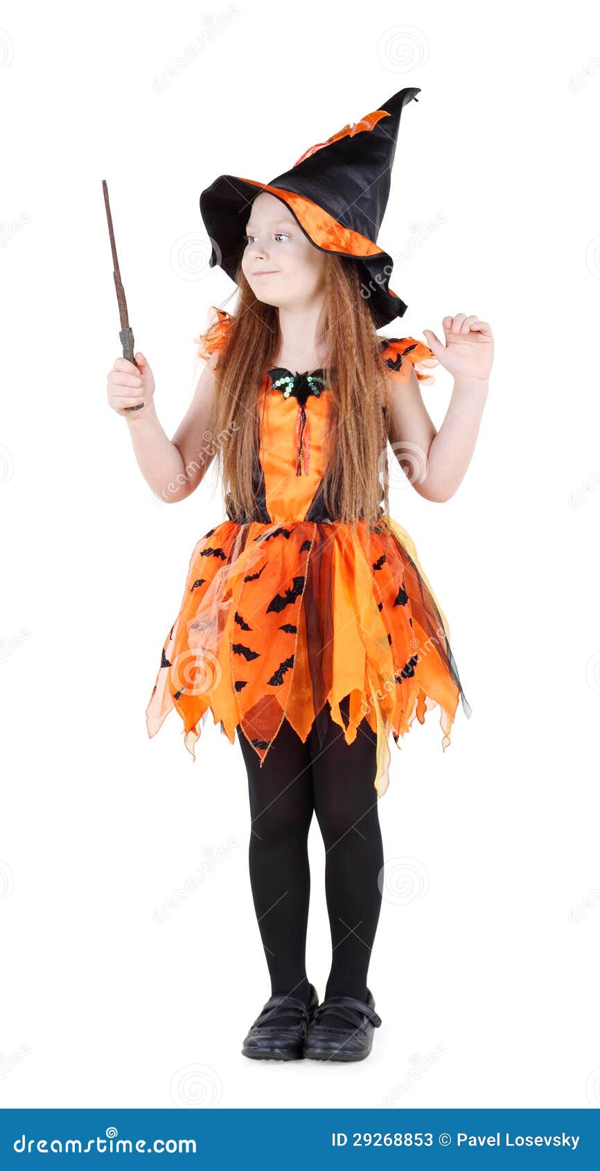 little girl in orange costume of witch for halloween
