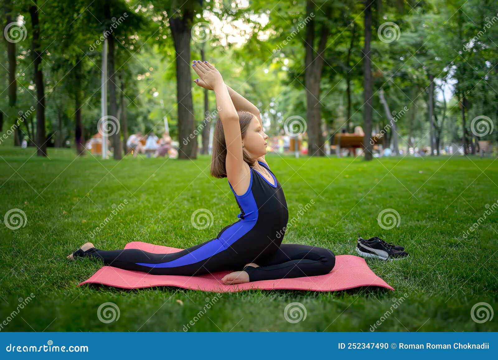A Little Girl in the Park Performs Yoga Elements by Bending Cullen and ...