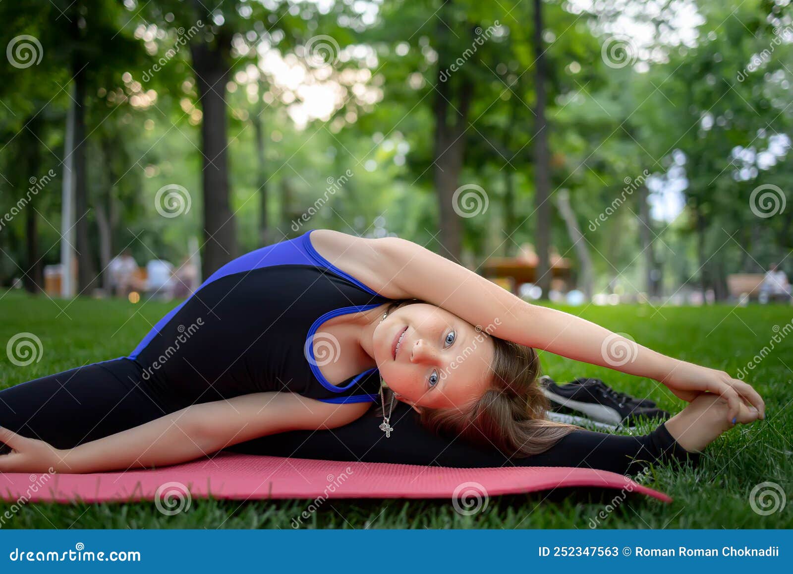 A Little Girl Performs Yoga Elements Leaning To the Side Stretching Her ...