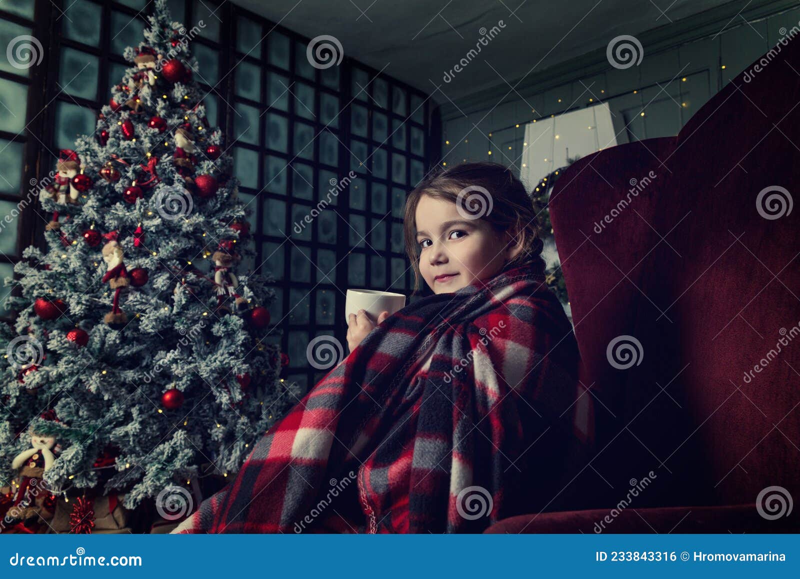 A Little Girl with Pigtails Drinks Tea from a White Mug Wrapped in a ...