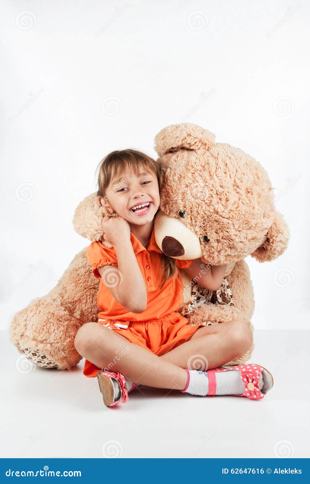 little girl playing teddy bear white background 62647616