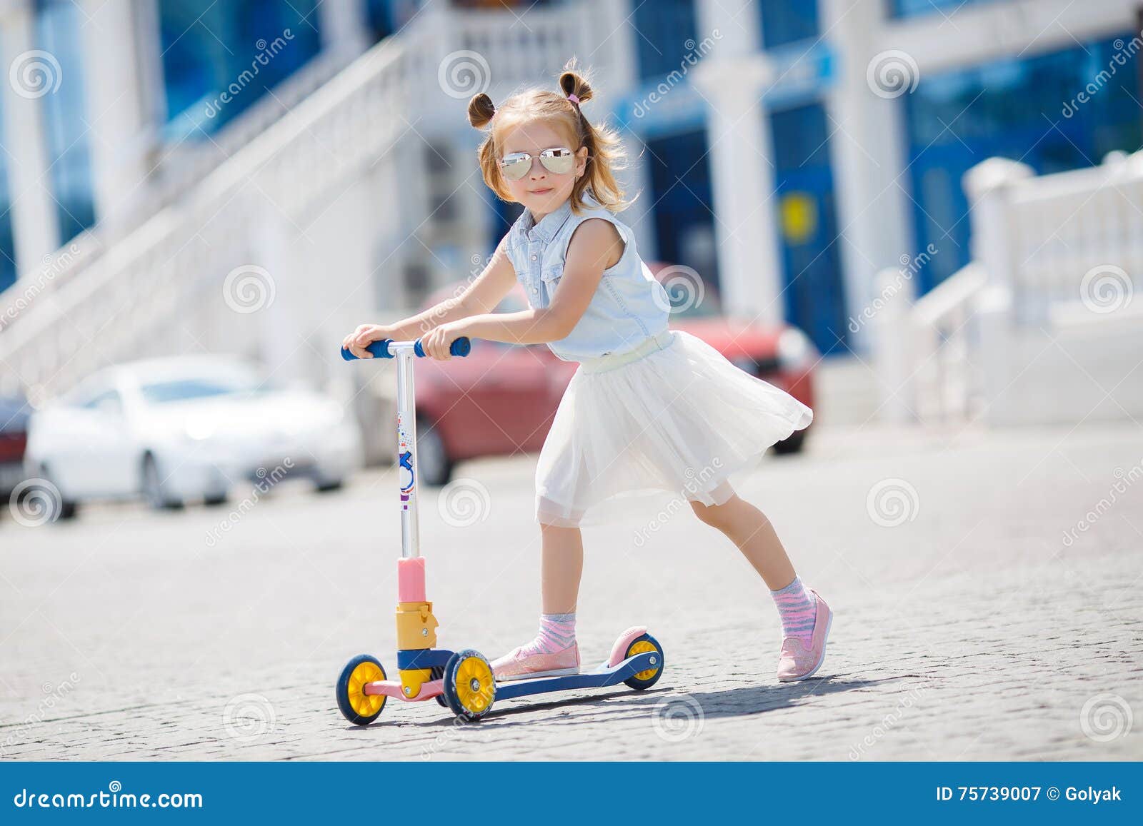 little girl riding scooter