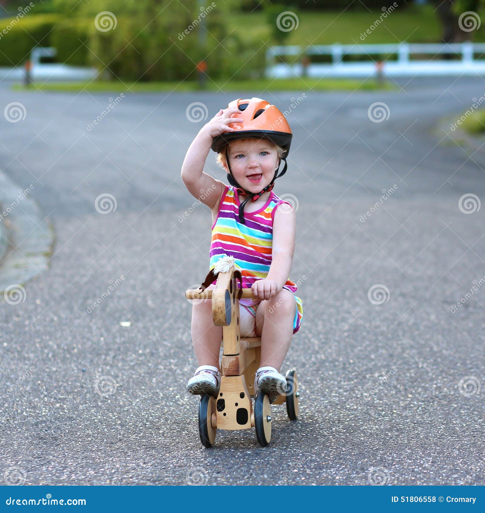 girl riding tricycle