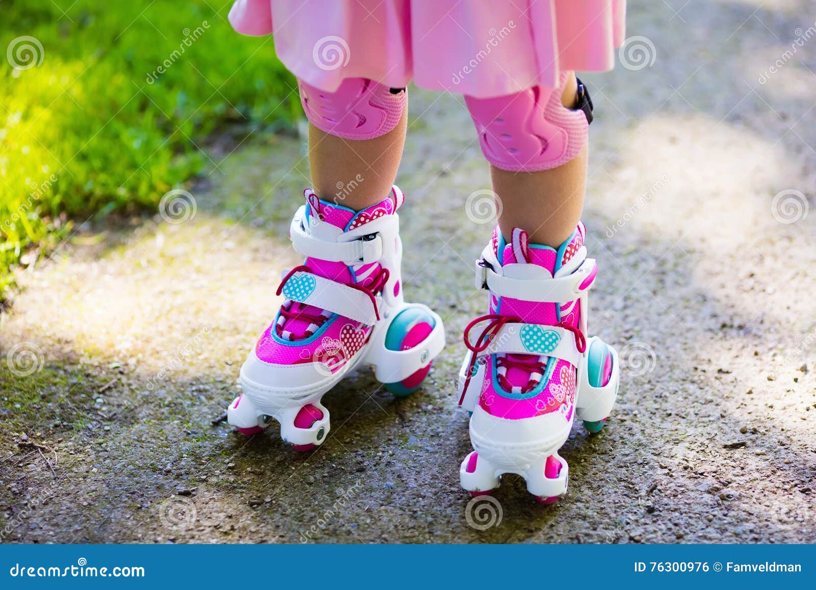 Little Girl Learning To Roller Skate In Sunny Summer Park. Child Wearing  Protection Elbow And Knee Pads, Wrist Guards And Safety Helmet For Safe  Roller Skating Ride. Active Outdoor Sport For Kids.