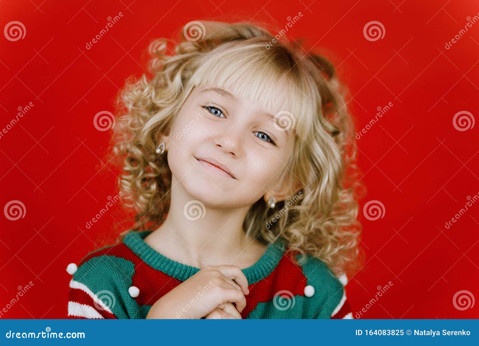 Little Girl In Santa Elf Helper Costume On Bright Red Vivid