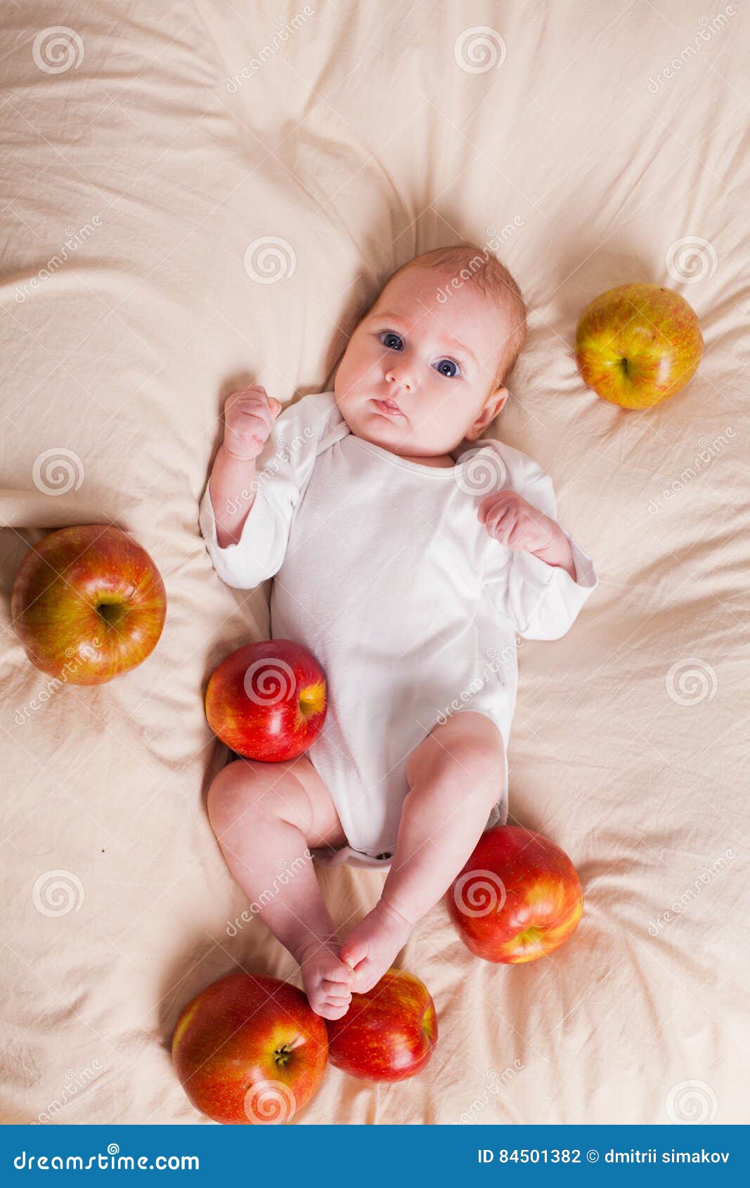 The Little Girl is Sitting on a Bed with Apples Stock Photo Image of