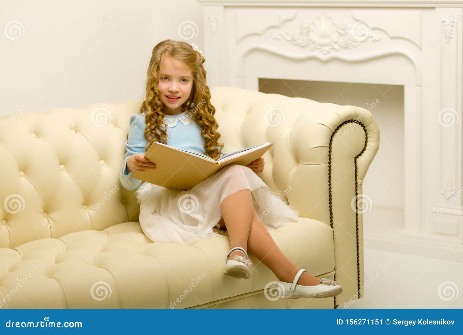 Little Girl Is Sitting On The Couch Stock Image Image of