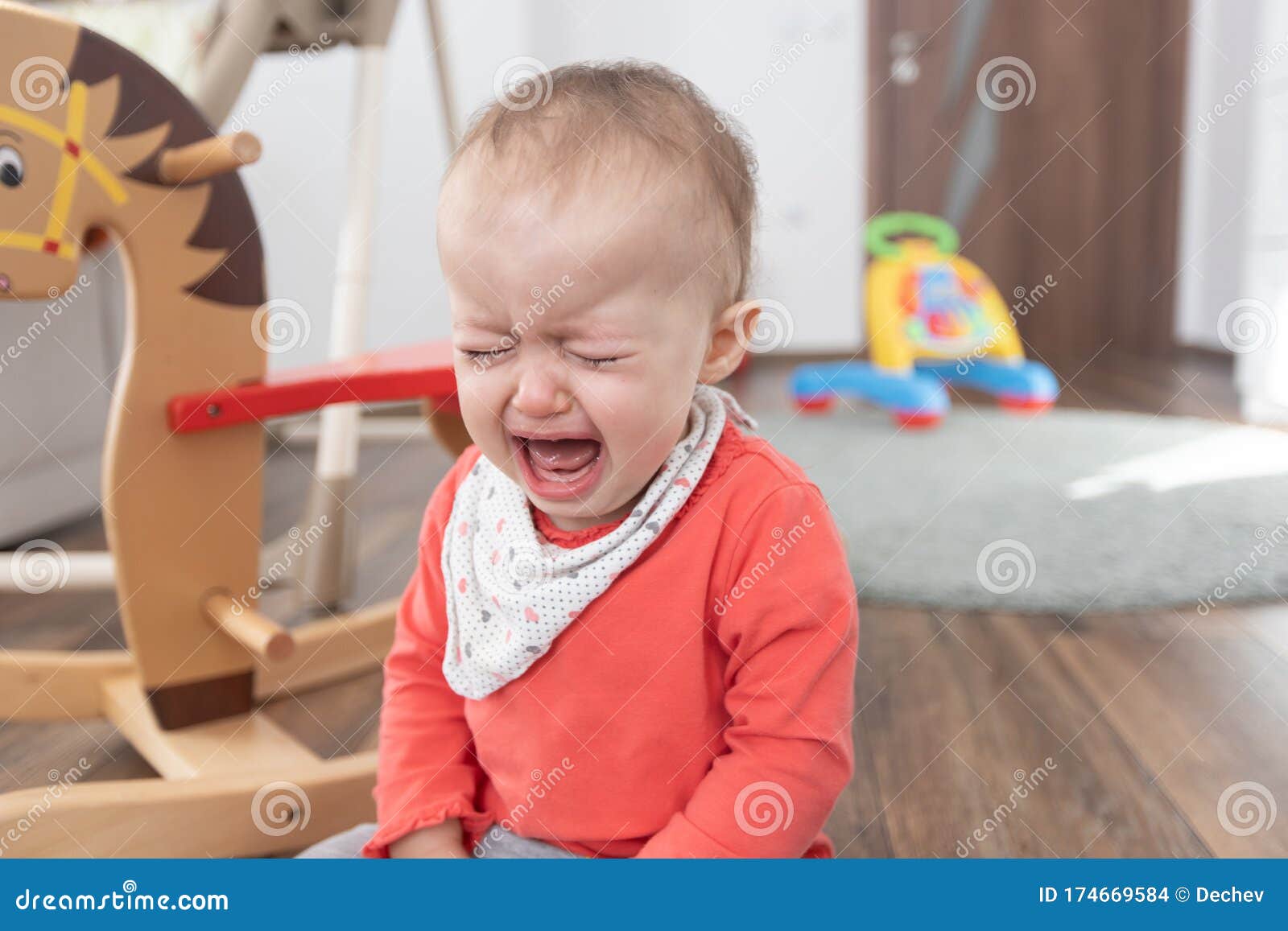 Girl Sitting on the Floor at Home and Crying. One Year Old Baby Crying ...