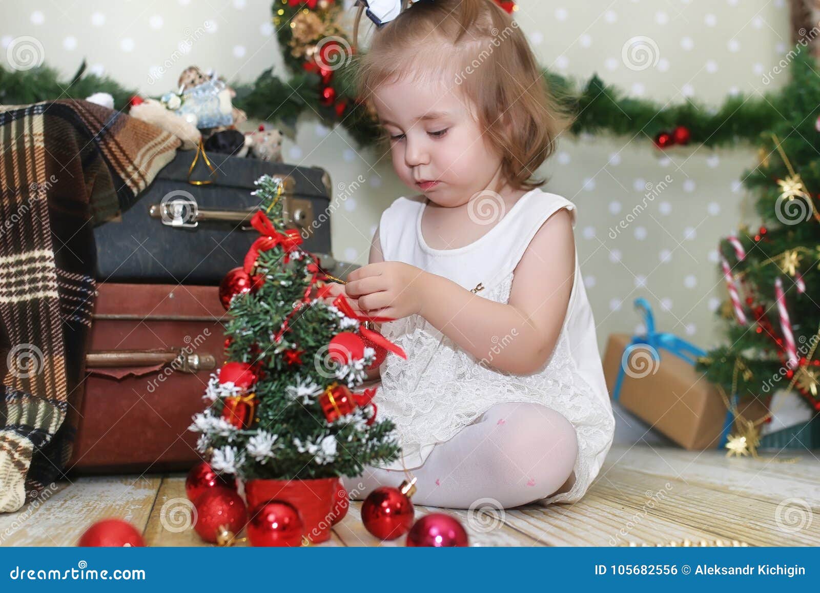 Little Girl Sitting in Front of a Christmas Tree Stock Photo - Image of ...