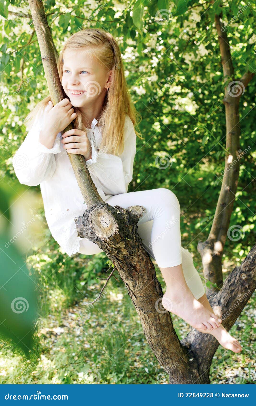 Little Girl Sitting on a Tree and Chatting His Legs Stock Photo - Image ...