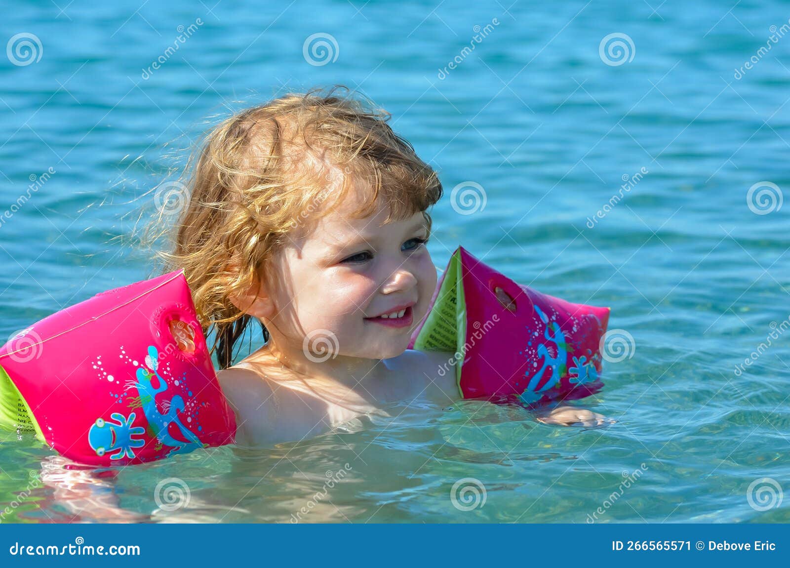 Little Girl Splashing in the Crystal Clear Water in a Lagoon Stock ...