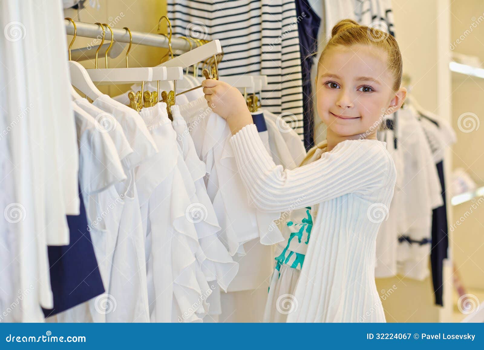 Little Girl Takes Hanger with Skirt from Stand Stock Image - Image of ...