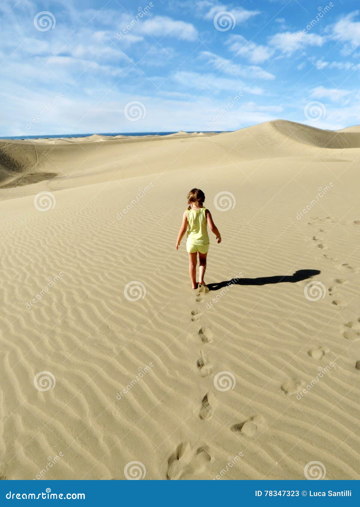A Little Girl Walk and Leaves Footprints on Desert Sand Dune Stock ...