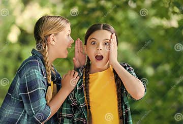 Little Girl Whisper in Friends Ear Listening with Curious Look Summer