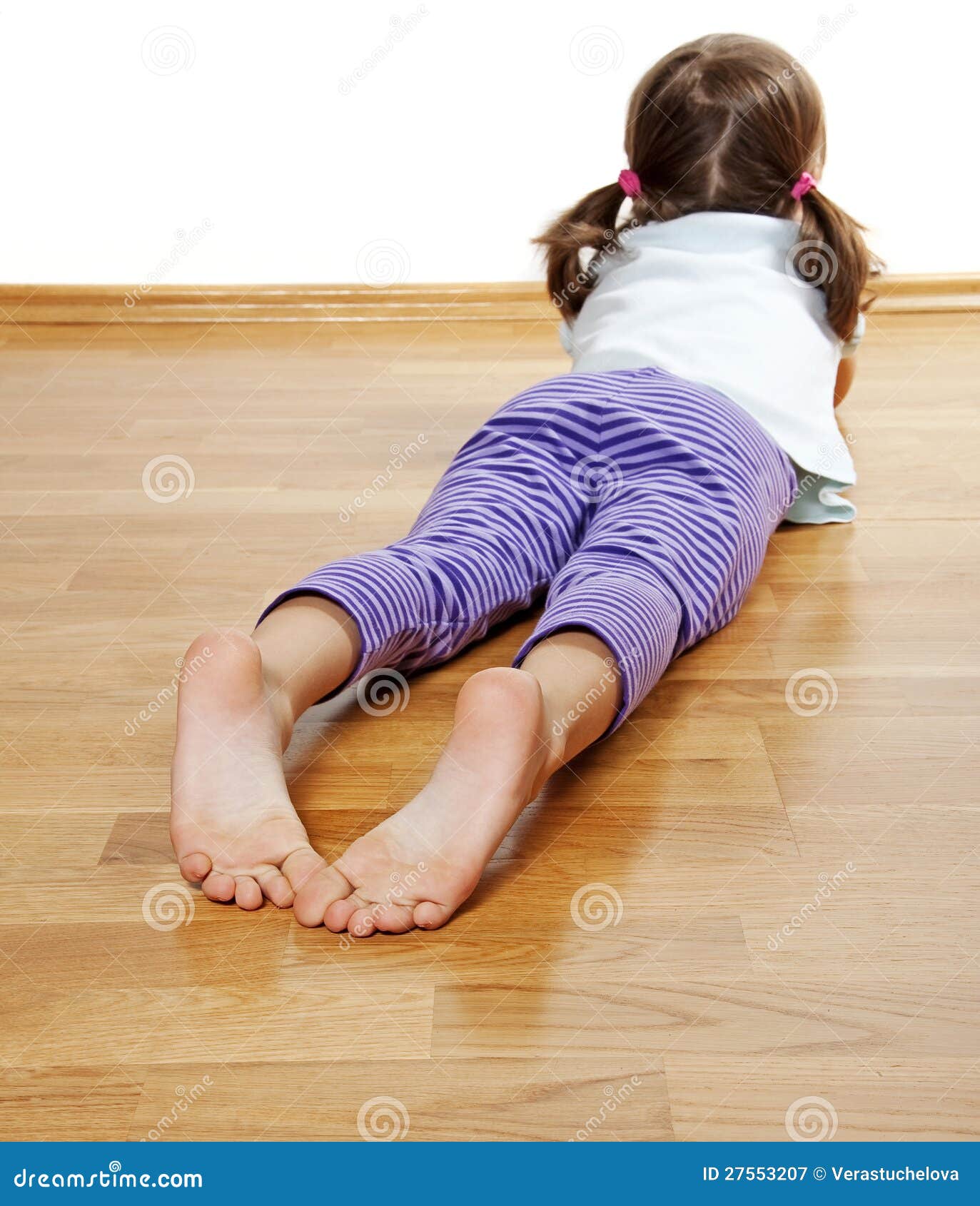 A Little Girl on a Wooden Floor Stock Image - Image of cute, rest: 27553207