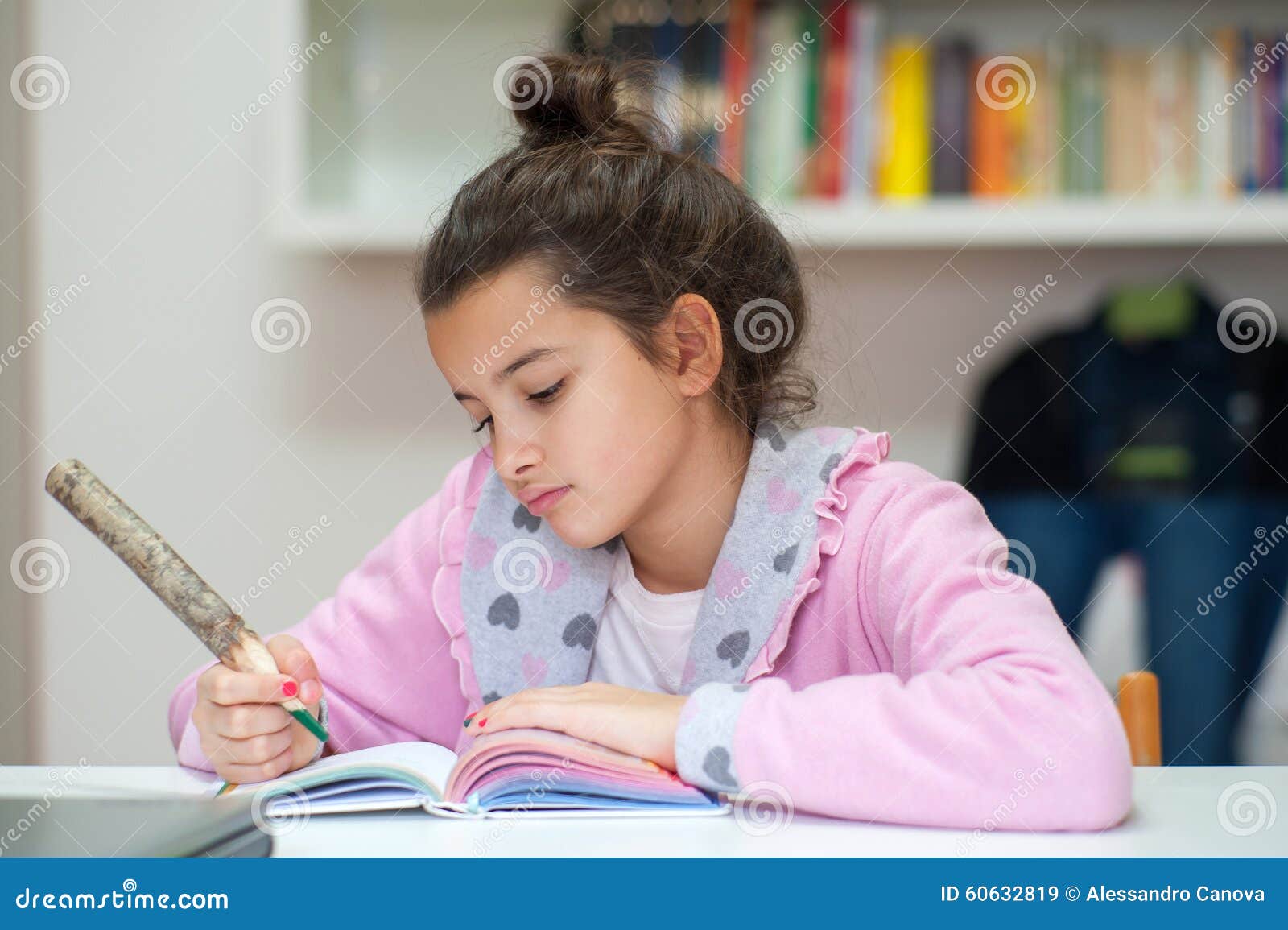 little girl writes on the school diary