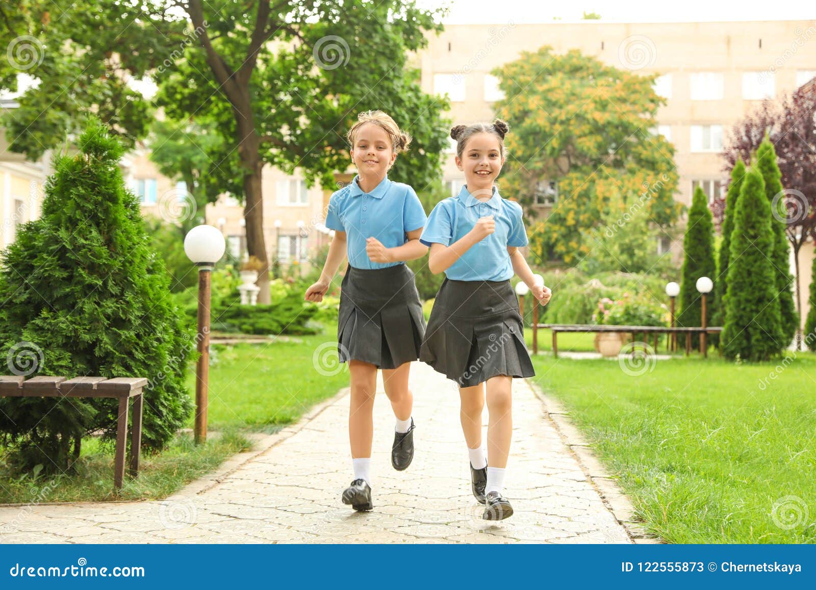 Boy In School Uniform Eating Potato Chip In Playground RoyaltyFree