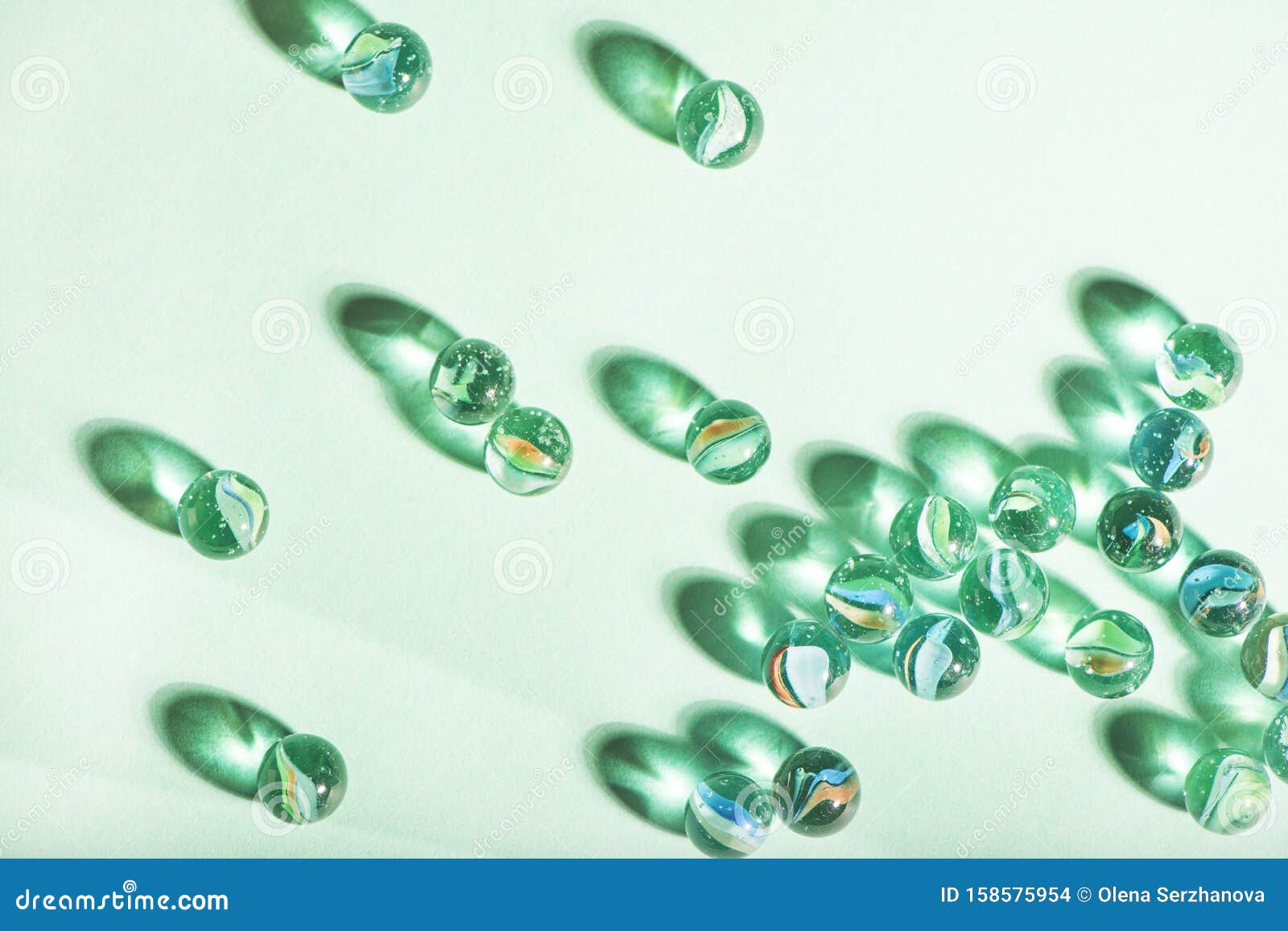 Little Glass Balls on Mint Background. Stock Photo Image of blurred
