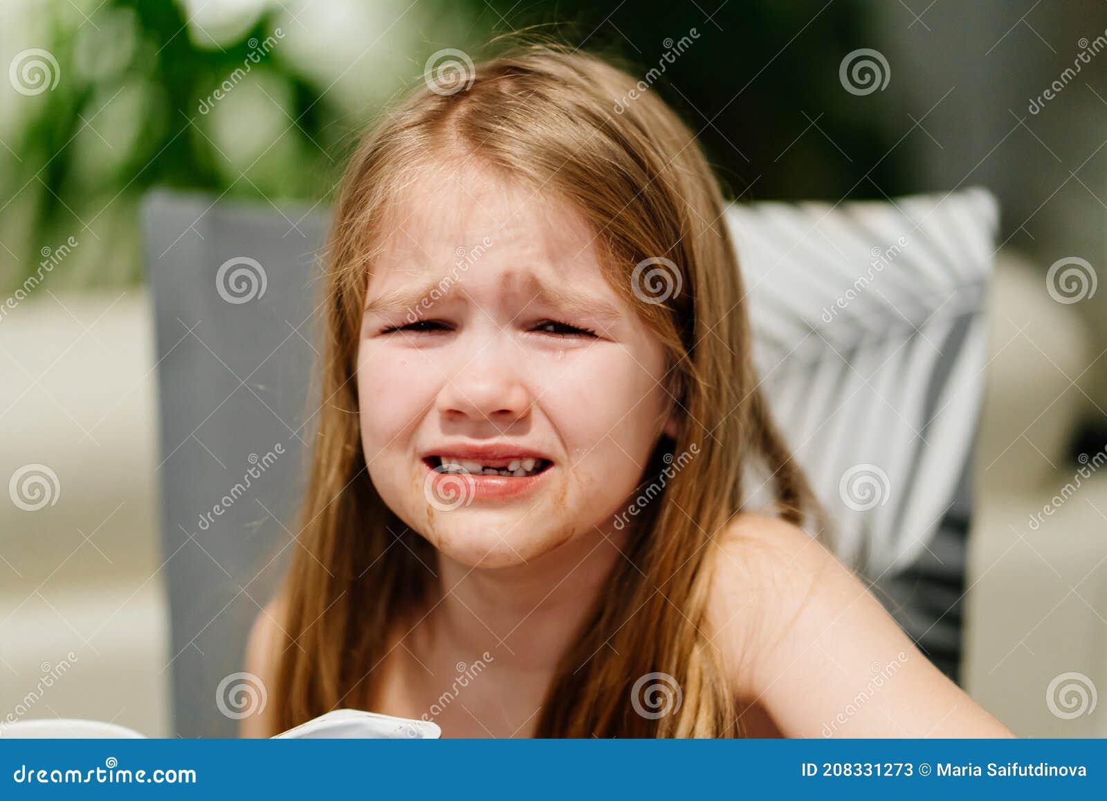 little girl cries at kitchen table saying i didn't