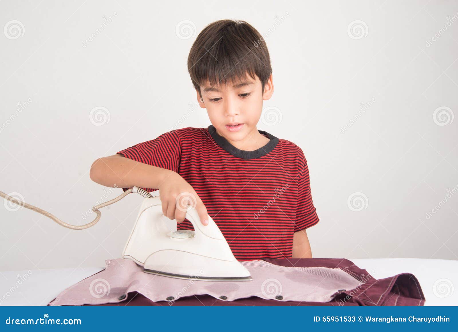 Kids Ironing Clothes For Baby Brother RoyaltyFree Stock Photo