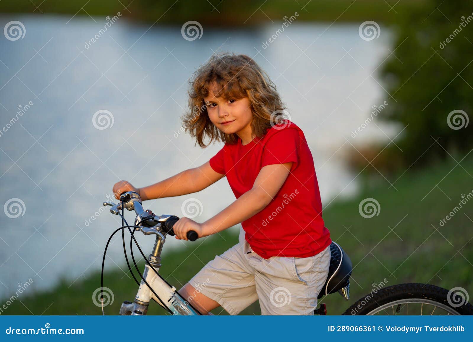 Little Kid Boy Riding a Bike in Summer Park. Child Drive a Bike on a ...