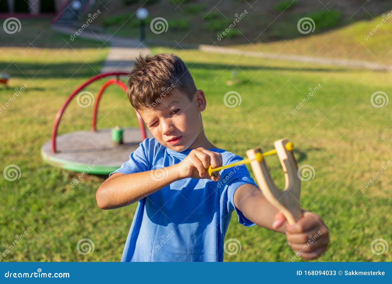 Little Kid Shooting with Slingshot at Playground Stock Image Image of