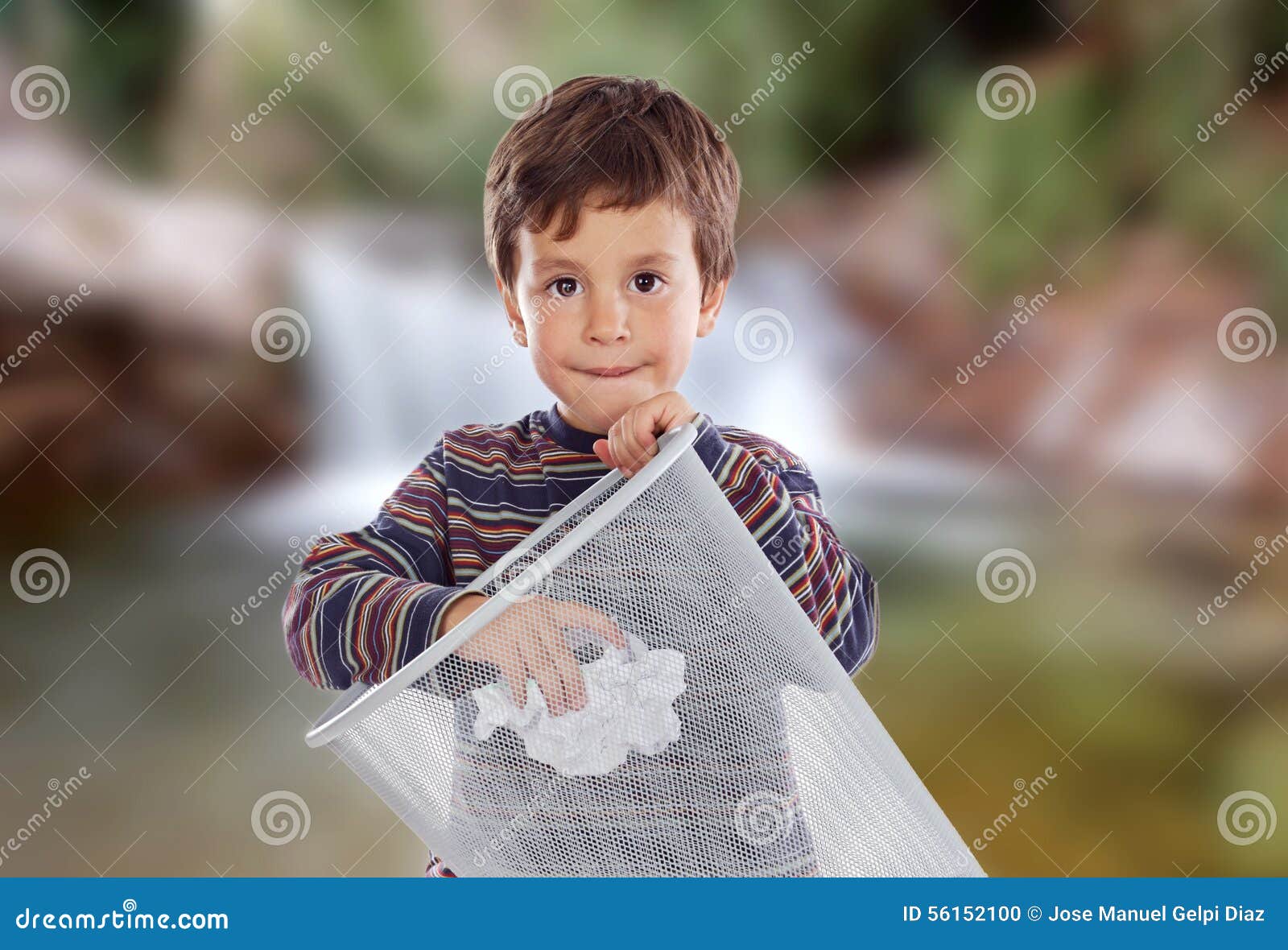 Little Kid Throwing a Paper in the Bin. Stock Photo Image of litter
