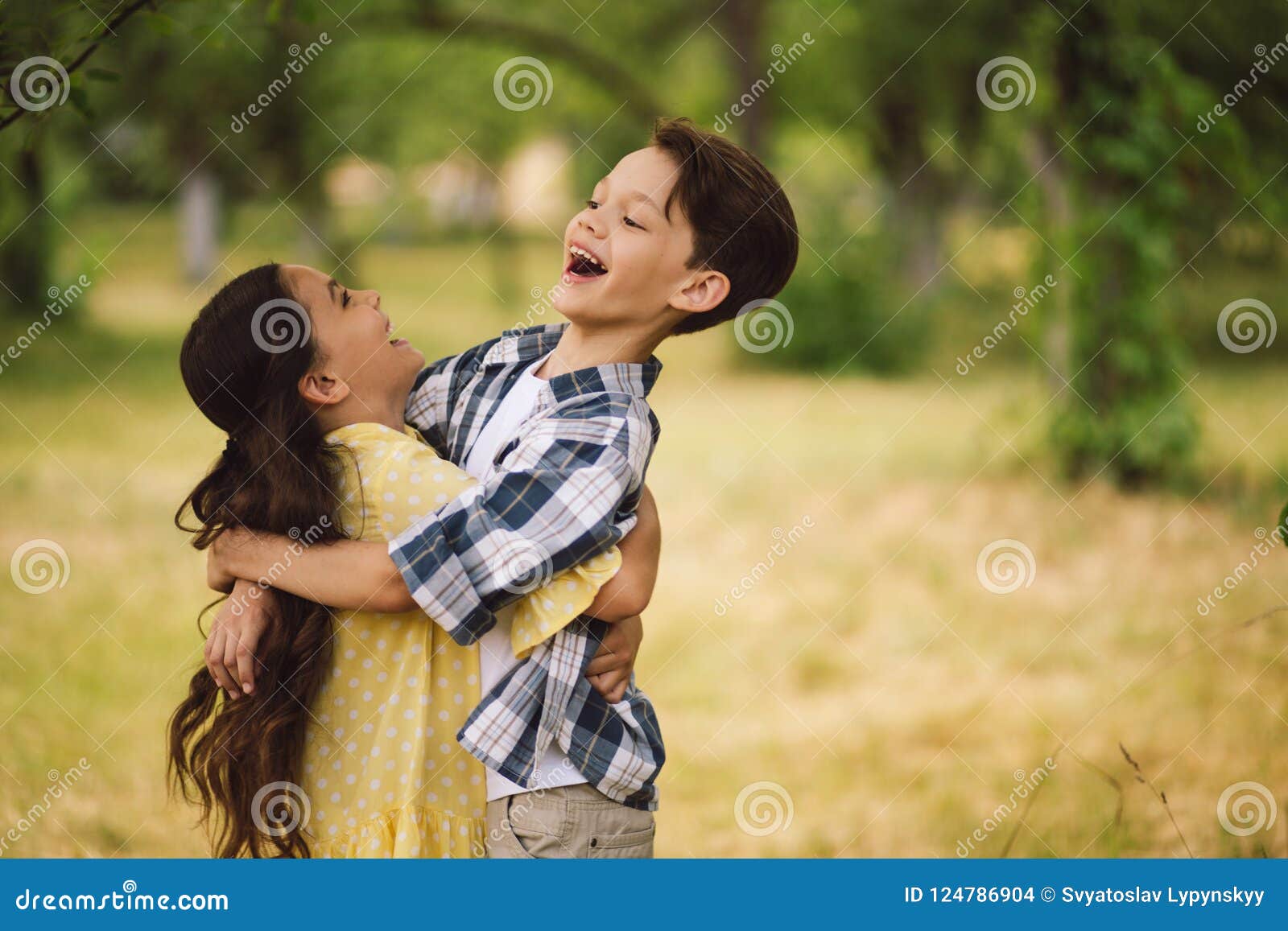 Little kids hugging. stock photo. Image of love, flower - 124786904