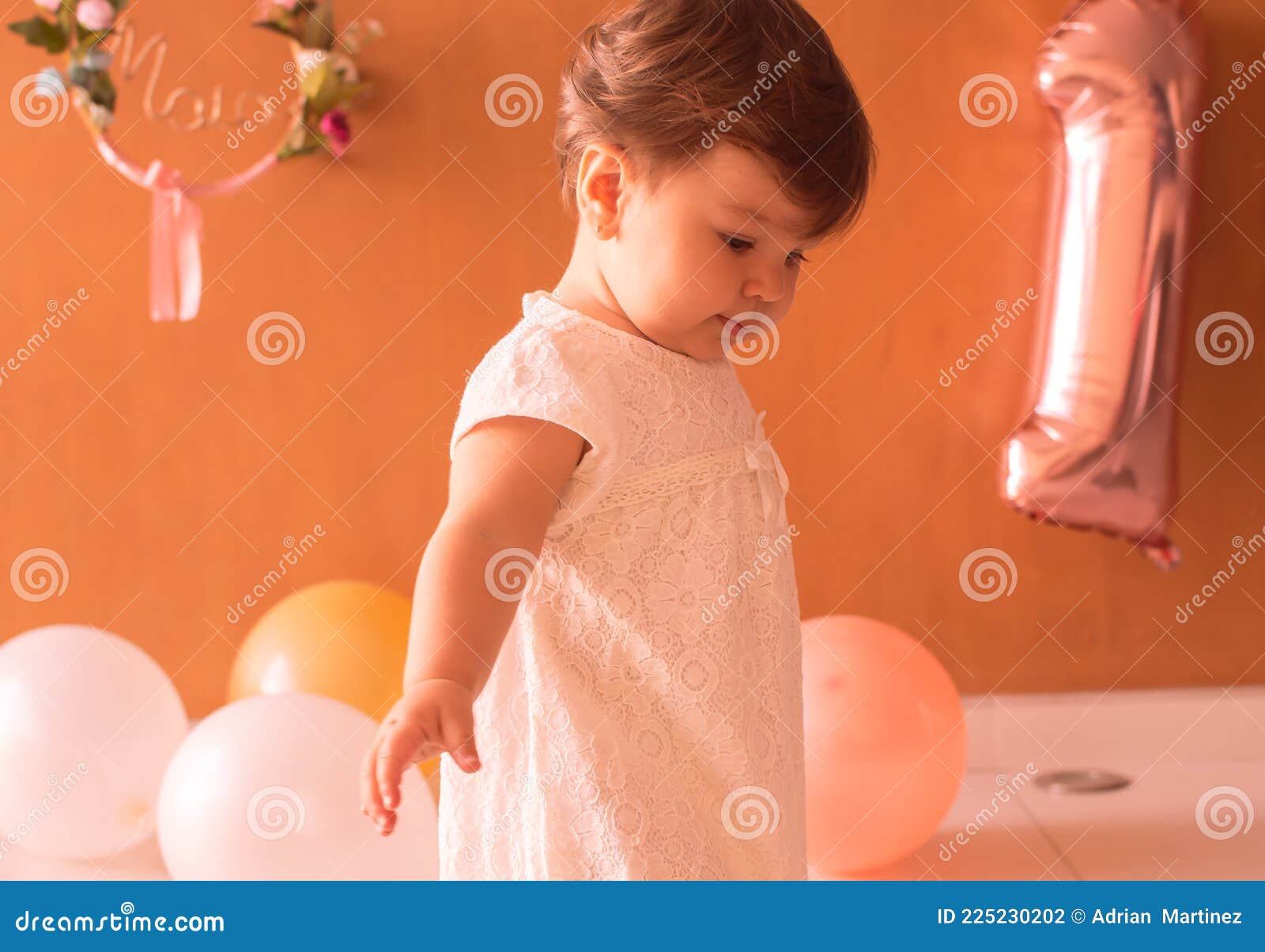 little one year girl baby with balones and dolly