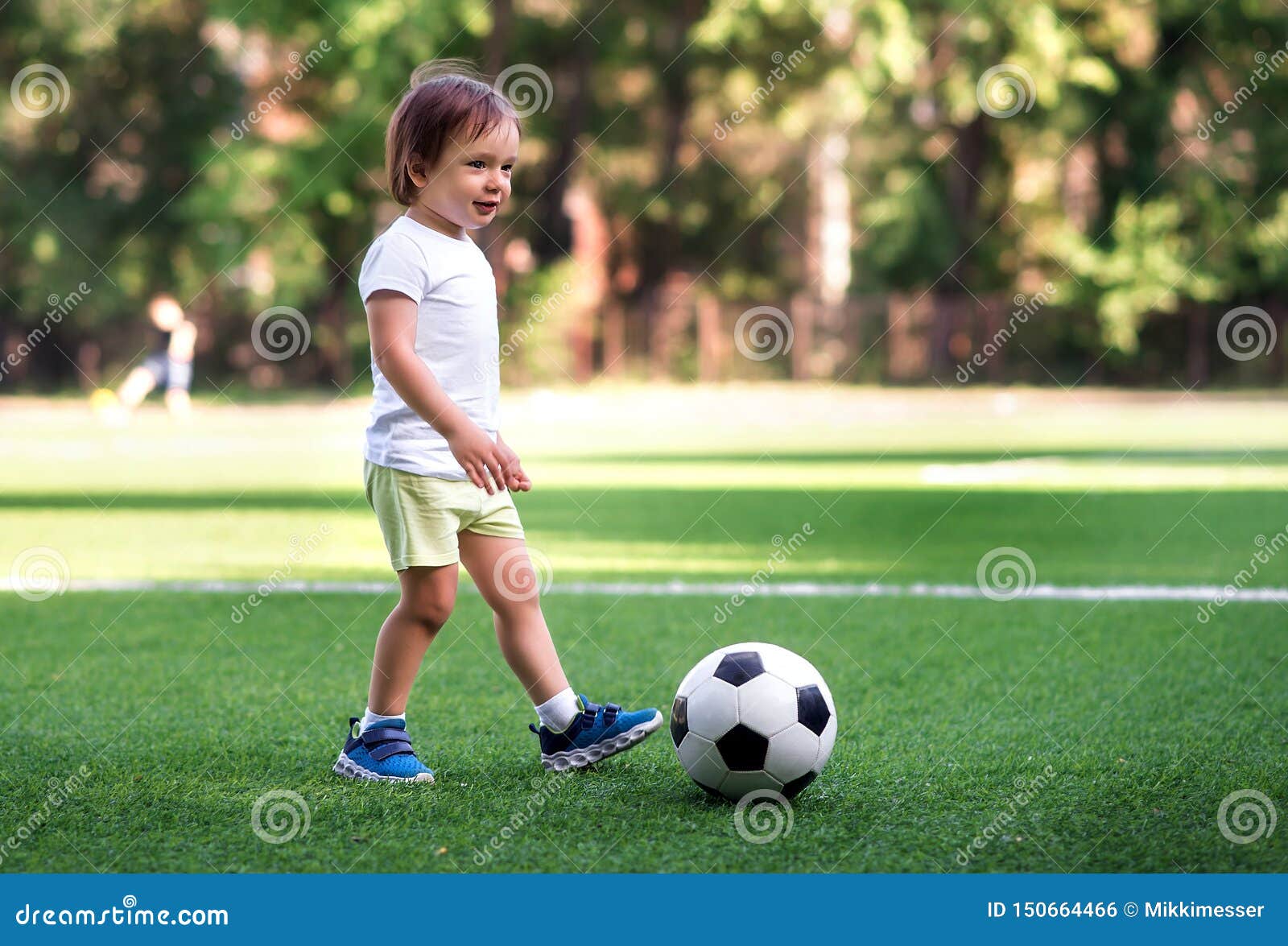 Little Player: Toddler Boy in Sports Uniform Playing Footbal at Soccer  Field in Summer Day Outdoors. Child Ready To Kick Ball Stock Photo - Image  of goal, outdoors: 150664466