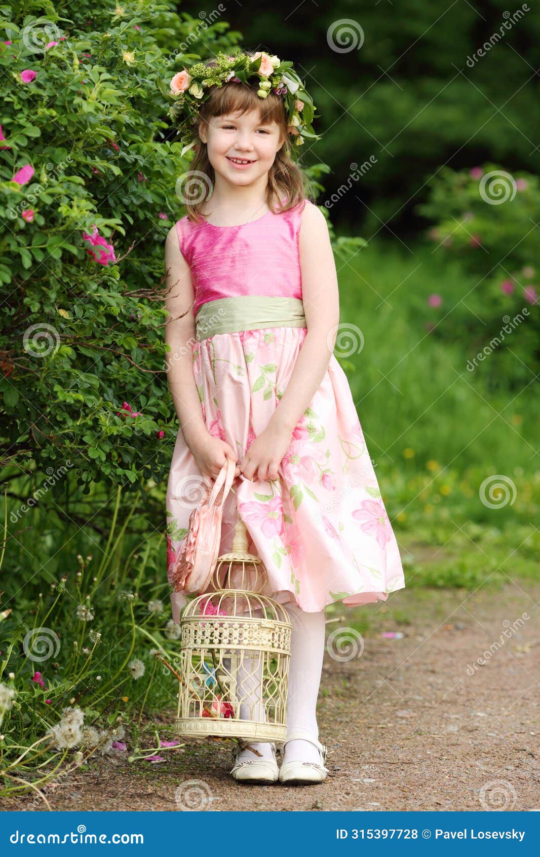 little pretty girl holds coop with butterflies and