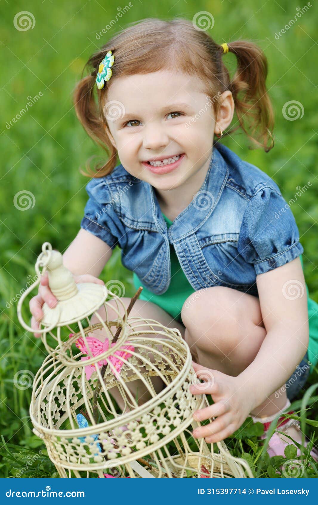 little pretty girl holds coop with butterflies and