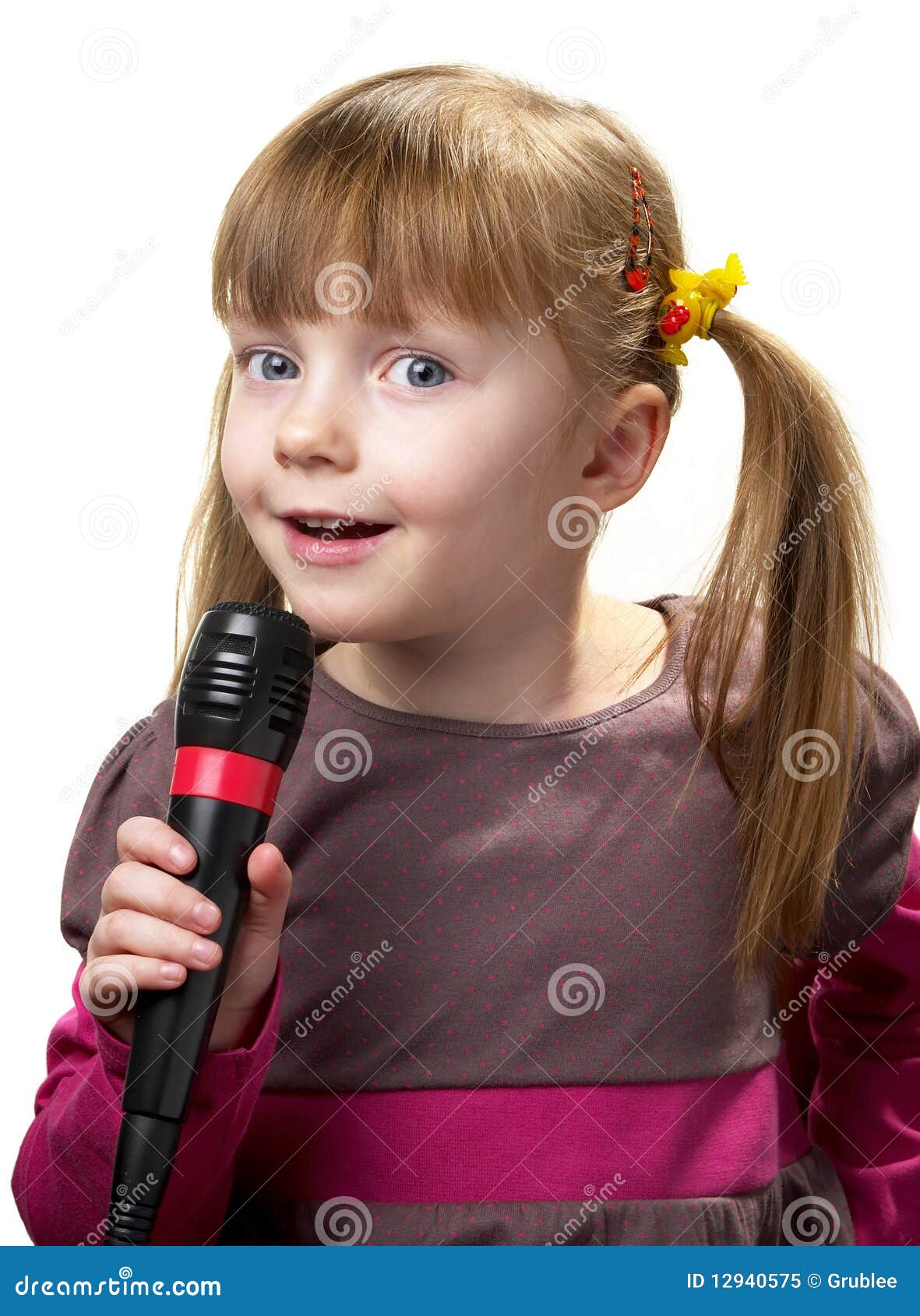 Little singer. Funny little girl singing with microphone isolated over white background