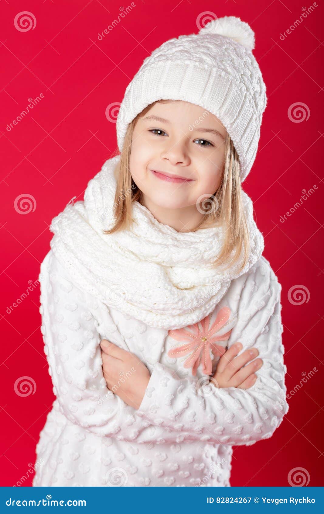 Little Smiling Blonde Girl in a White Hat and Scarf on Red Backg Stock ...