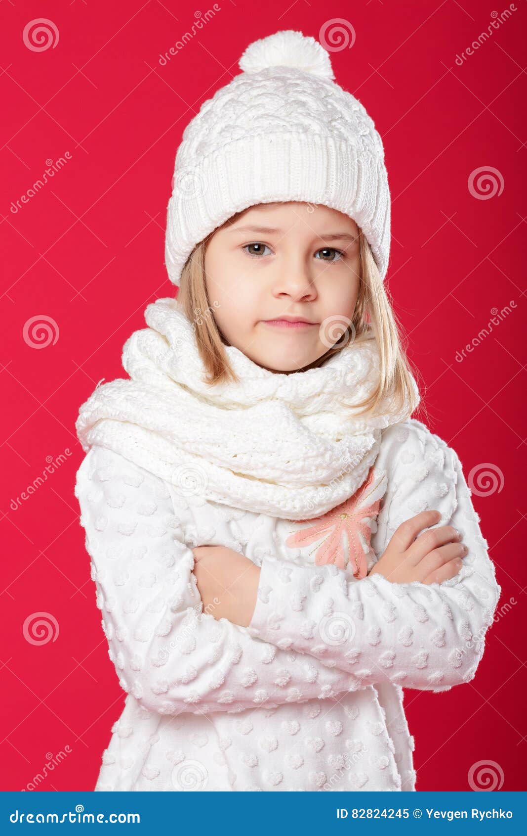 Little Smiling Blonde Girl in a White Hat and Scarf on Red Backg Stock ...