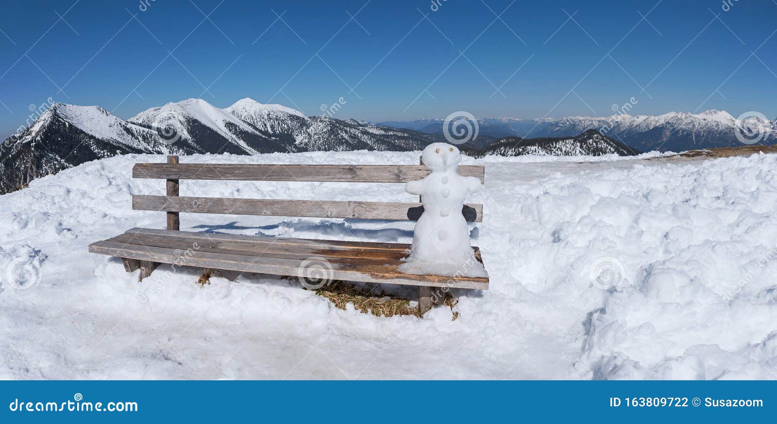 Little Snowman Sitting at a Wooden Bench in the Bavarian Alps Stock ...