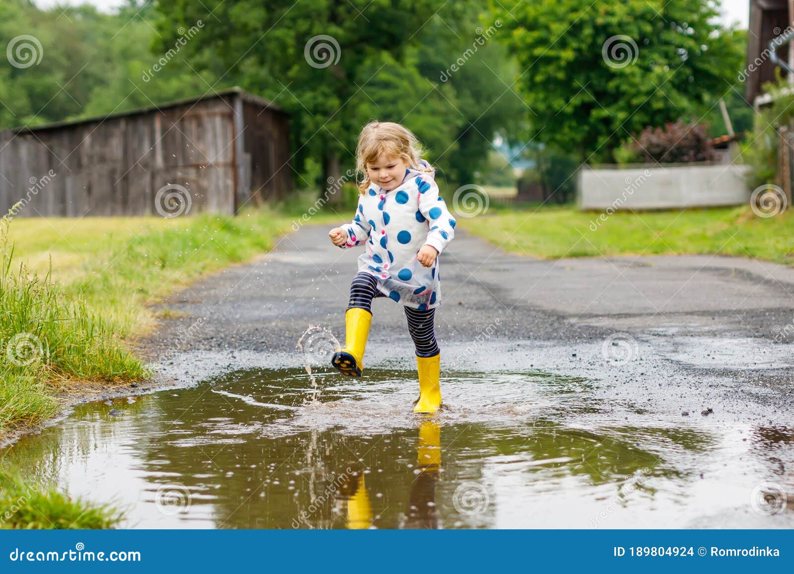 Little Toddler Girl Wearing Yellow Rain Boots, Running and Walking ...