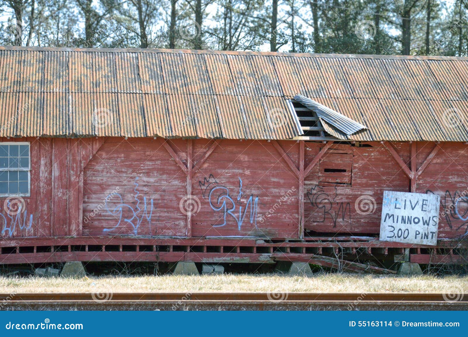 Live Minnows, Dilapidated House by the Train Tracks. Stock Photo