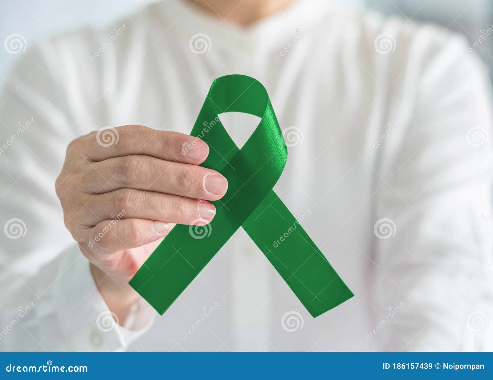 Top View Of Emerald Green Ribbon On Dark Wood Background Liver Cancer  Awareness Concept High-Res Stock Photo - Getty Images