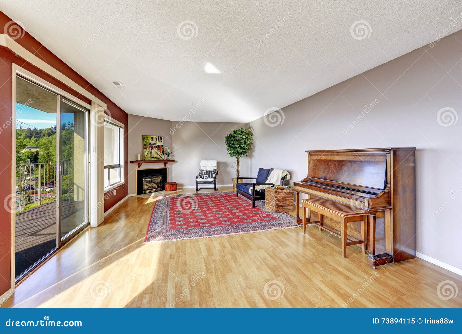 Living Room With Hardwood Floor Fireplace Piano And Rug Stock
