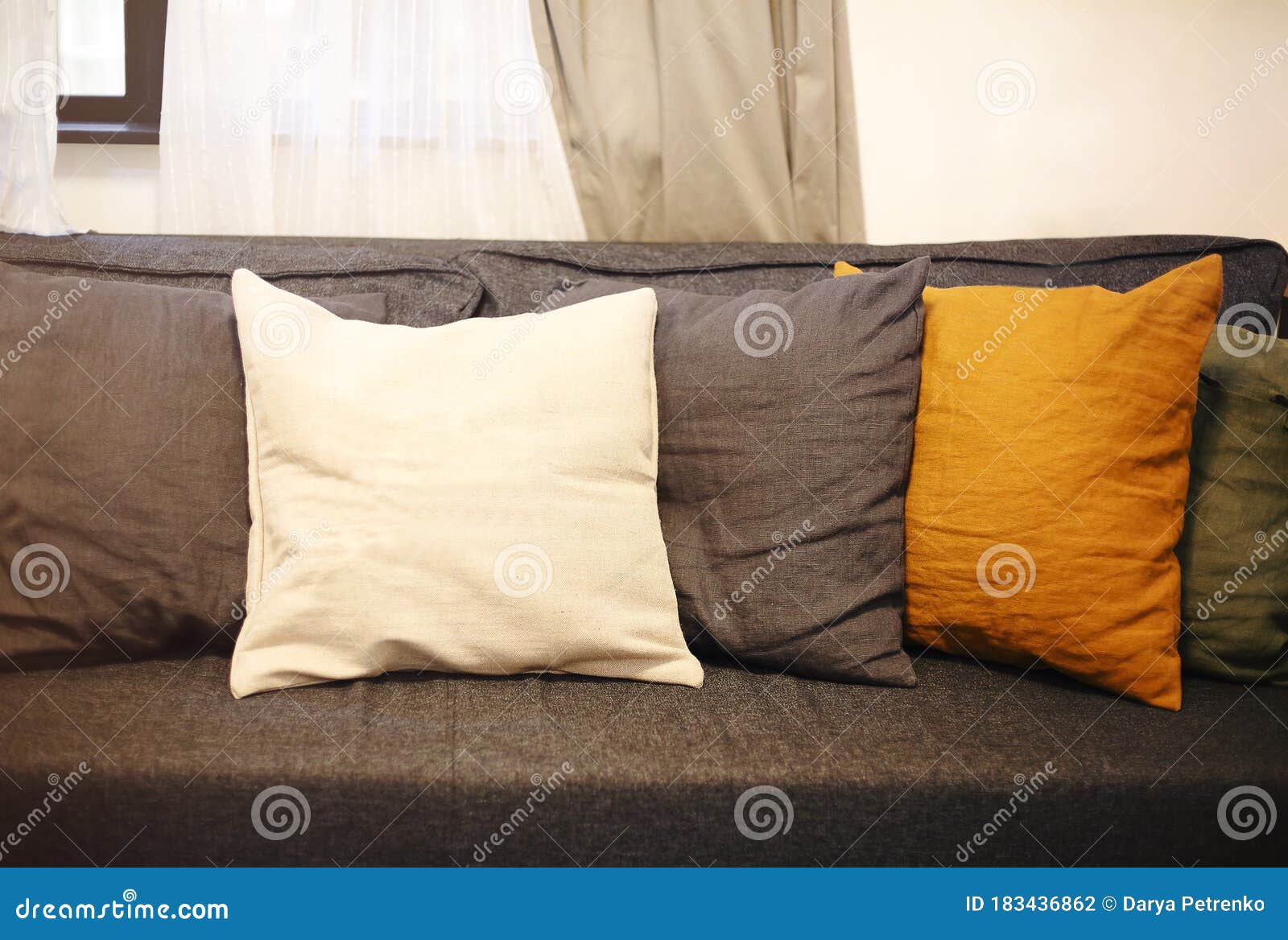 Living Room Interior with Grey Sofa and Yellow Pillows Stock Photo
